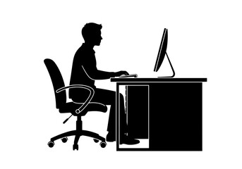 Fototapeta premium Silhouette of a man working on a computer at a desk