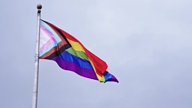 LGBT community. Tolerance and equality. World gay pride. Rainbow gay flag. Pride month. LGBTQ rainbow flag. LGBT rainbow flag waving against sky. Symbol of pride and LGBTQ. Colorful pride flag