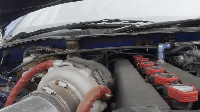 Closeup engine bay with turbo piping red ignition coils, braided heat wrap, polished intake pipe, visible cam gears, timing belt area, glossy metallic finishes, trackready tuning feel, exhibition
