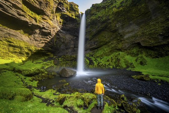 Tourist at Kvernufoss waterfall, in summer when the weather is nice, gorge and river, long exposure, Skogar, Sudurland, South Iceland, Iceland