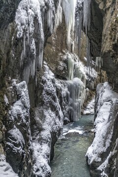 Wild river Partnach in the Partnachklamm with long icicles and snow in winter, near Garmisch-Partenkirchen, Upper Bavaria, Bavaria, Germany