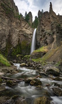 Waterfall flowing through eroded landscape with rock outcrops, Tower Fall with Tower Creek, Yellowstone National Park, Wyoming, USA