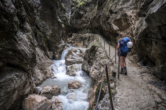 Hiker in a gorge, Hammersbach flows through H&ouml;llentalklamm, near Garmisch-Partenkirchen, Werdenfelser Land, Upper Bavaria, Bavaria, Germany