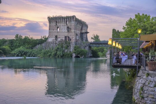 Restaurant on the Mincio River and Visconti Bridge dating back to 1395, Borghetto, Valeggio sul Mincio, Province of Verona, Italy