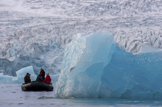Dinghy with tourists in front of the glacier edge of Monacobreen, iceberg, Liefdefjord, Woodfjord area, Spitsbergen Island, Svalbard and Jan Mayen archipelago, Norway
