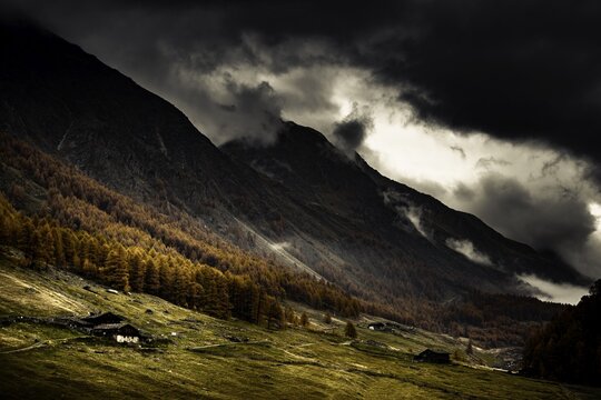 Alpine hut in autumnal mountain landscape with threatening cloudy sky, Pfossental, Merano, Vinschgau, South Tyrol, Italy