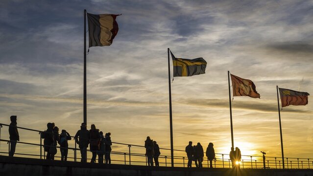 People, silhouettes, flags, harbour in Lindau on Lake Constance, Bavaria, Germany