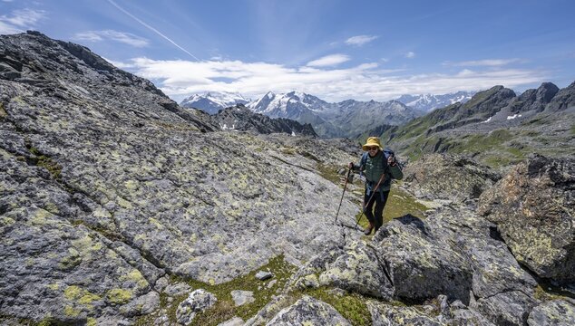 Mountaineer in rocky mountain landscape at the Col du Louvie, view of the summit of the Grand Combine, Valais Alps, Val de Bagnes, Valais, Switzerland