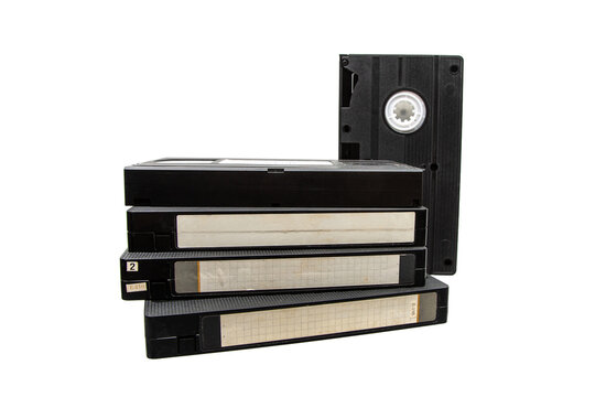 Stack of old black VHS video tapes with blank labels isolated on white back