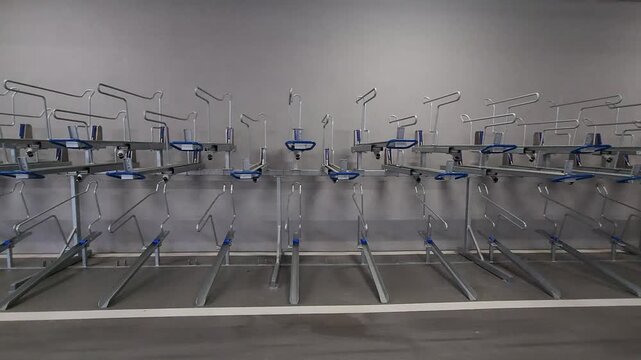 Empty modern double bike rack indoor facility, pan camera movement.