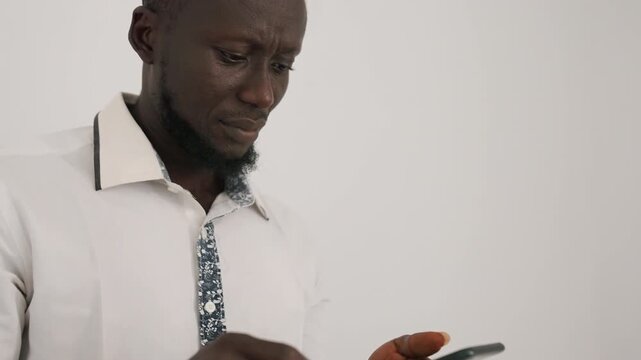 Man considers response on glowing screen. Contemplative man evaluates reply after romantic encounter. Man faces pivotal decision while reading message on his illuminated mobile device