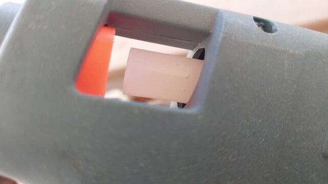 Detail of glue stick feeding mechanism in a hot glue gun