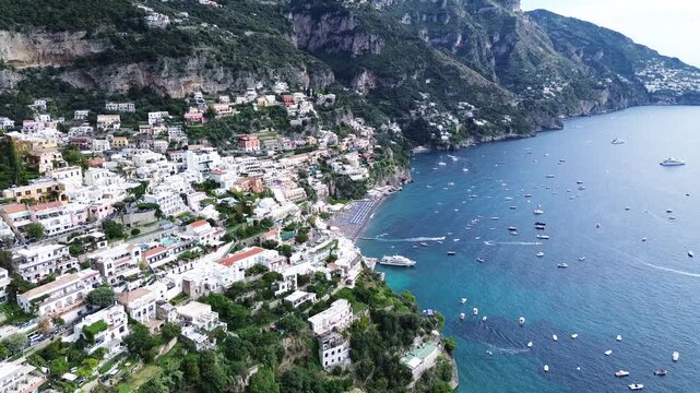 Thyrenian Sea and row of bright umbrellas on beach of Positano - famous old italian resort, Italy