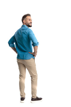 Back view of confident casual man standing looking away