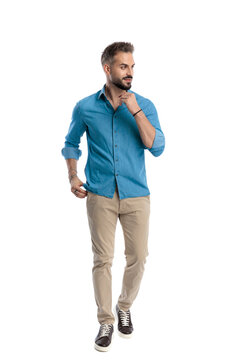 Thoughtful casual man walking and looking away