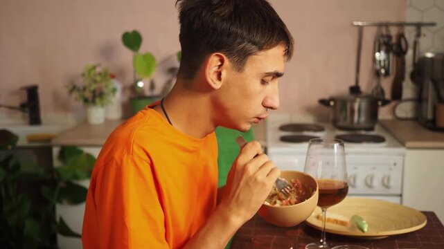 Satisfied man having breakfast at kitchen closeup.