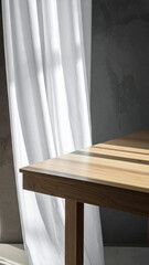 Fototapeta premium Vertical close up of an empty wooden table with warm natural sunlight and shadows from flowing white curtains in a minimalist room for product mockup and organic lifestyle brand photography