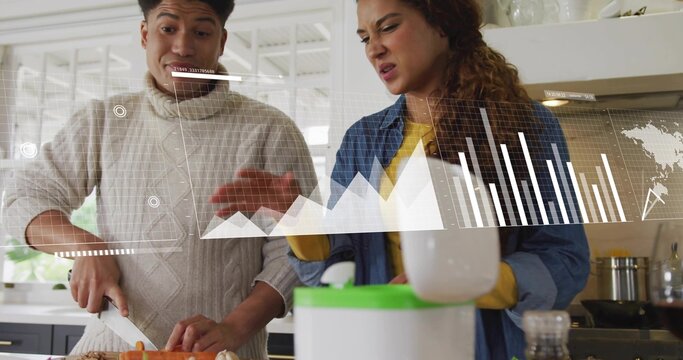 Chopping couple in denim preparing meal with knife at home counter with green blender data overlay
