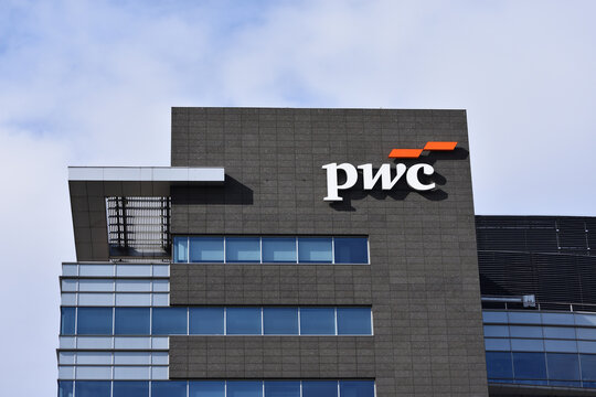 PWC PriceWaterhouseCoopers company office with logo, signage on the facade. WARSAW, POLAND - APRIL 30, 2026