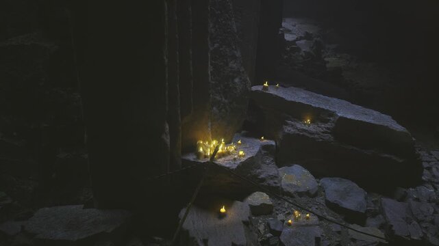 Small candle cluster on stone ledge, cold cave. Makeshift waypoint or discovery mark, scattered pebbles, warm flame contrasting blue shadows, tense adventurous