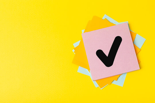 Stacked wooden cubes with check marks on background. Tick mark on check boxes. Checklist concept, tick on wooden blocks. Space for text.Space for text. Flat Lay