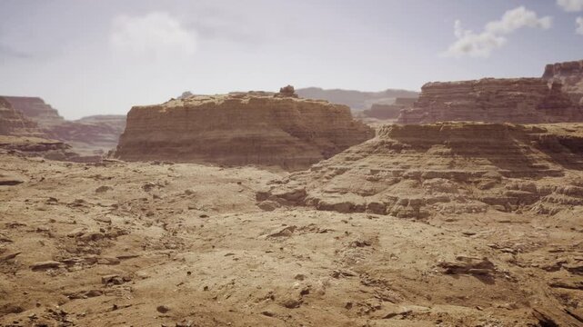 Cinematic western canyon with sweeping mesas and layered cliffs, soft haze in distance and textured foreground rock, warm tonal range creates classic filmic