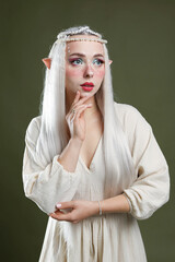 Naklejka premium Beautiful elf girl on dark olive background