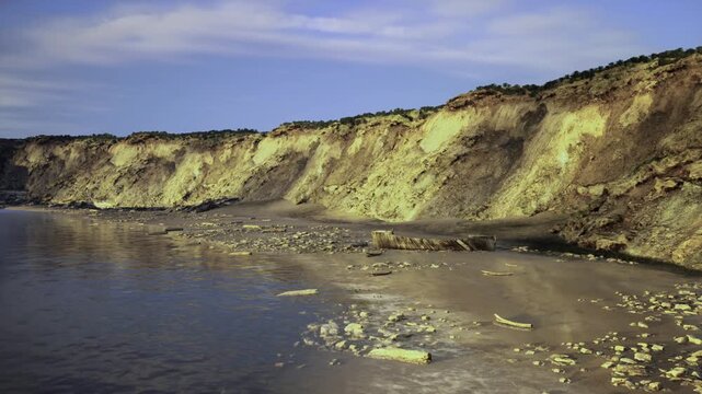 Stratified cliff site for study. Researchfriendly location on layered cliff face. Ideal site for geological investigation and educational purposes