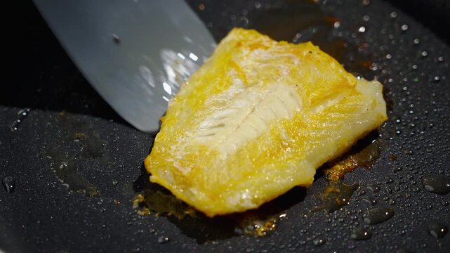 Frying white fish fillets. Frying hake fillets in a hot pan Surface indicators demonstrate that cod has been properly cooked and finished. Visual signs on surface of cod confirm it