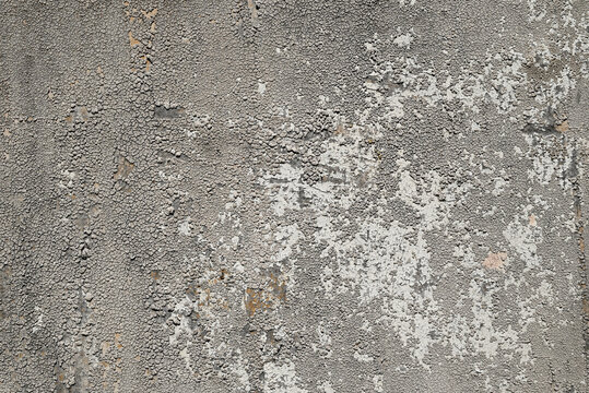 Old painted wall with peeling cracked paint and rough weathered texture. Distressed abstract background for overlays, banners and urban design.