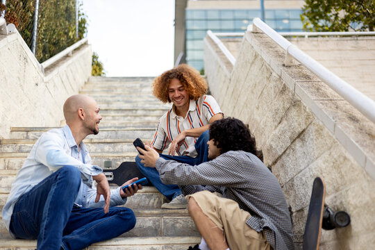 Friends skaters relaxing on urban steps with skateboards