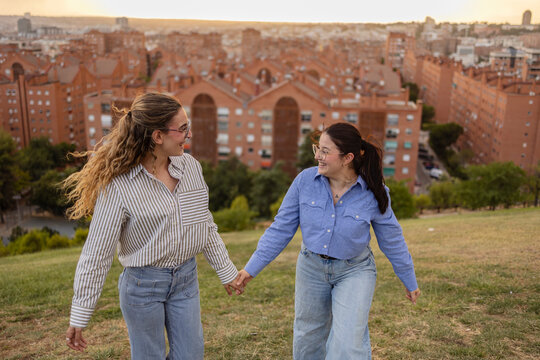 Friends enjoying Madrid skyline view during evening walk