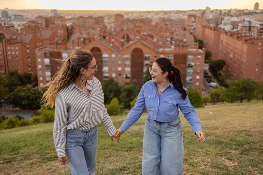 Friends enjoying Madrid skyline view during evening walk