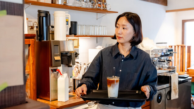 Barista serving coffee in a South Korean cafe
