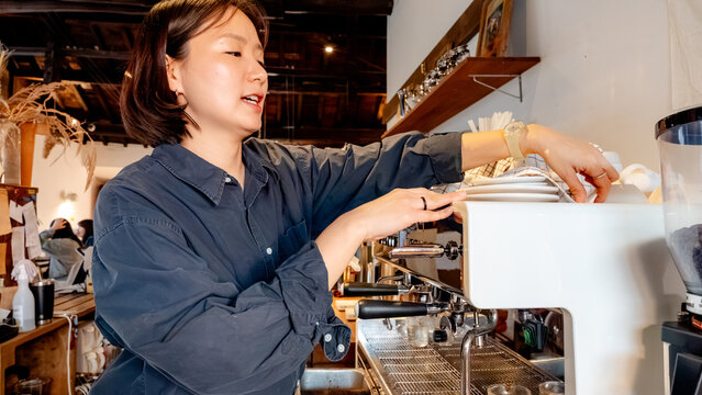 Barista cleaning coffee machine in South Korea