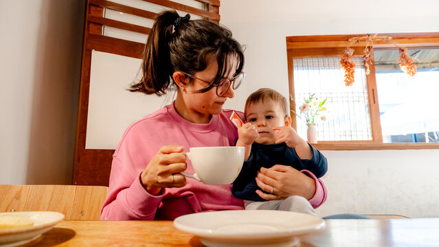 Mother and child enjoying a cozy coffee shop in Seoul
