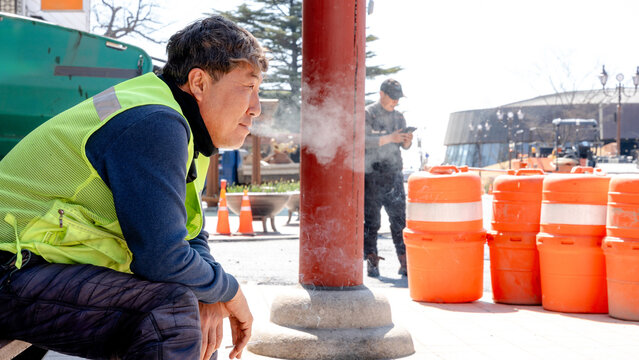 Workers pause during street paving in Gyeongju
