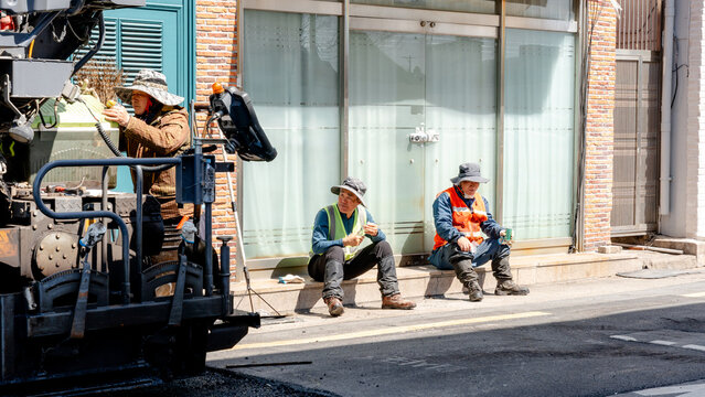 Road workers taking a break during street paving in Korea