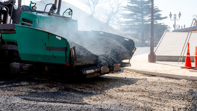 Asphalt paving machine during road repair construction