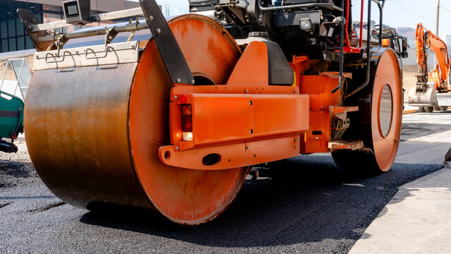 Asphalt paving and road repair with heavy machinery