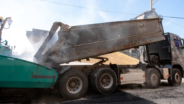 Road construction with asphalt paving and machinery