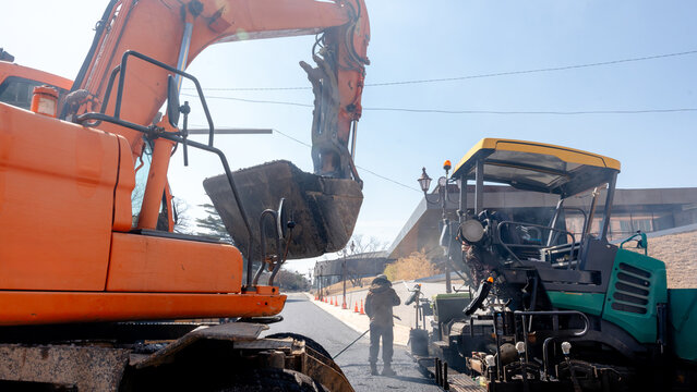 Road construction with machinery and workers