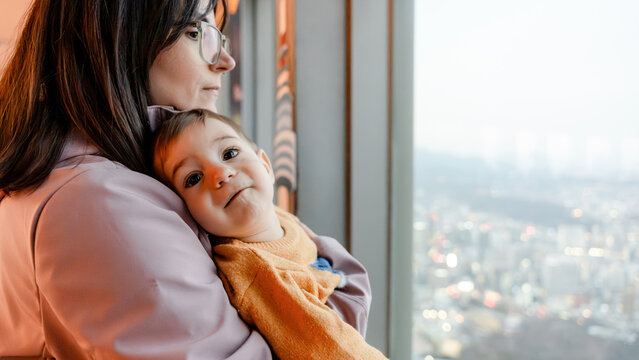 Mother and child overlooking cityscape from N Seoul Tower