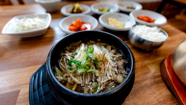 Korean bulgogi soup set with banchan and rice on table