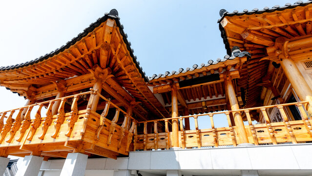 Traditional wooden Hanok architecture with ornate roof eaves