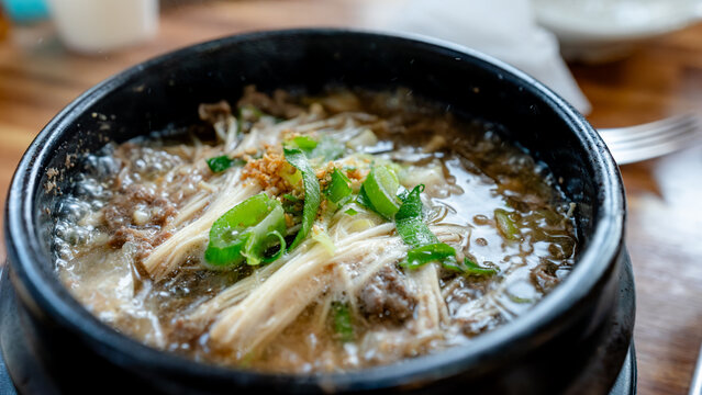 Steaming Korean bulgogi soup with mushroom in stone pot