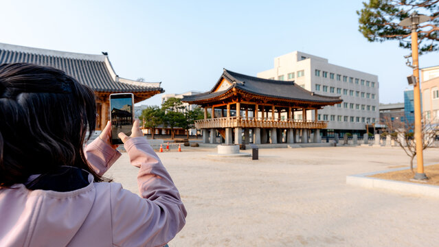 Tourist taking smartphone photo at Jeolla Gamyeong plaza