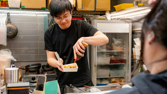 Taiwanese night market vendor preparing street food snack