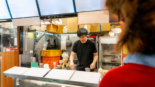 Taiwanese night market vendor cooking street food at stall