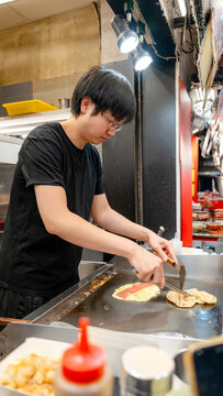 Taiwanese night market vendor cooking scallion pancake